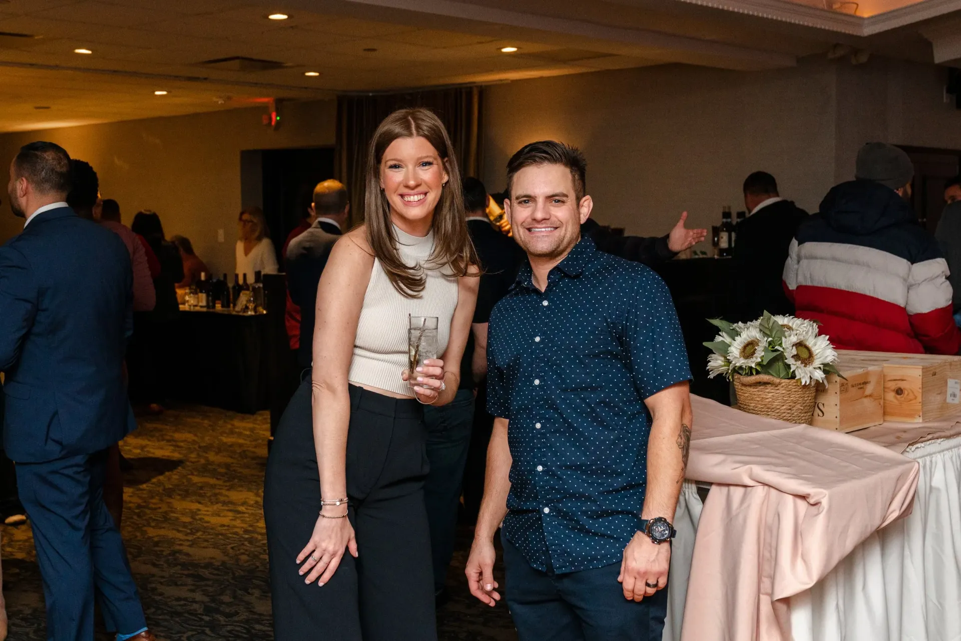 A man and a woman are posing for a picture at a party.