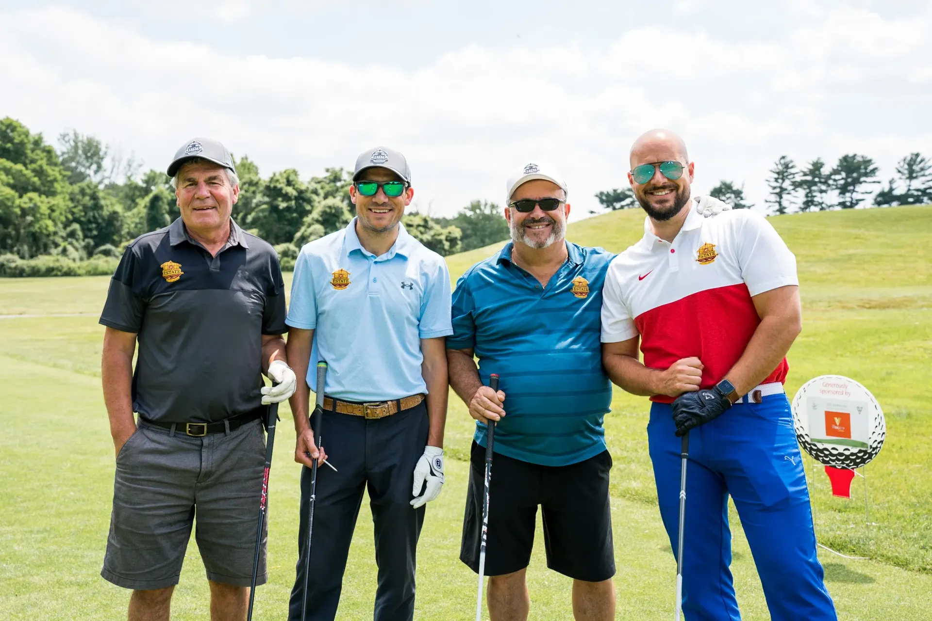A group of men are posing for a picture on a golf course.