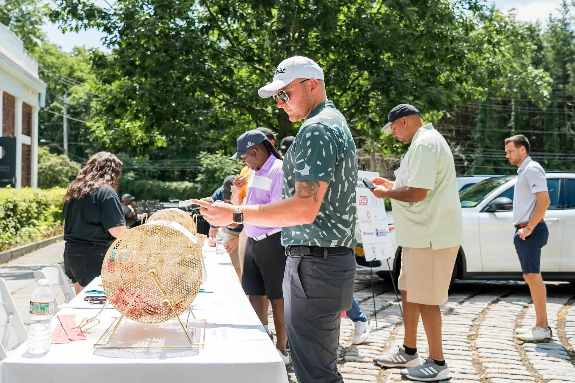 A group of people are standing around a table.