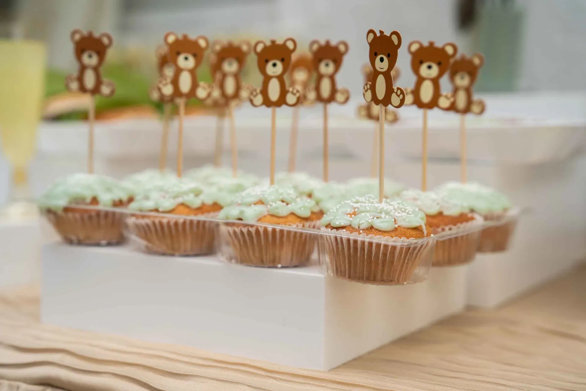 A table with two chairs and a white table cloth in a room.