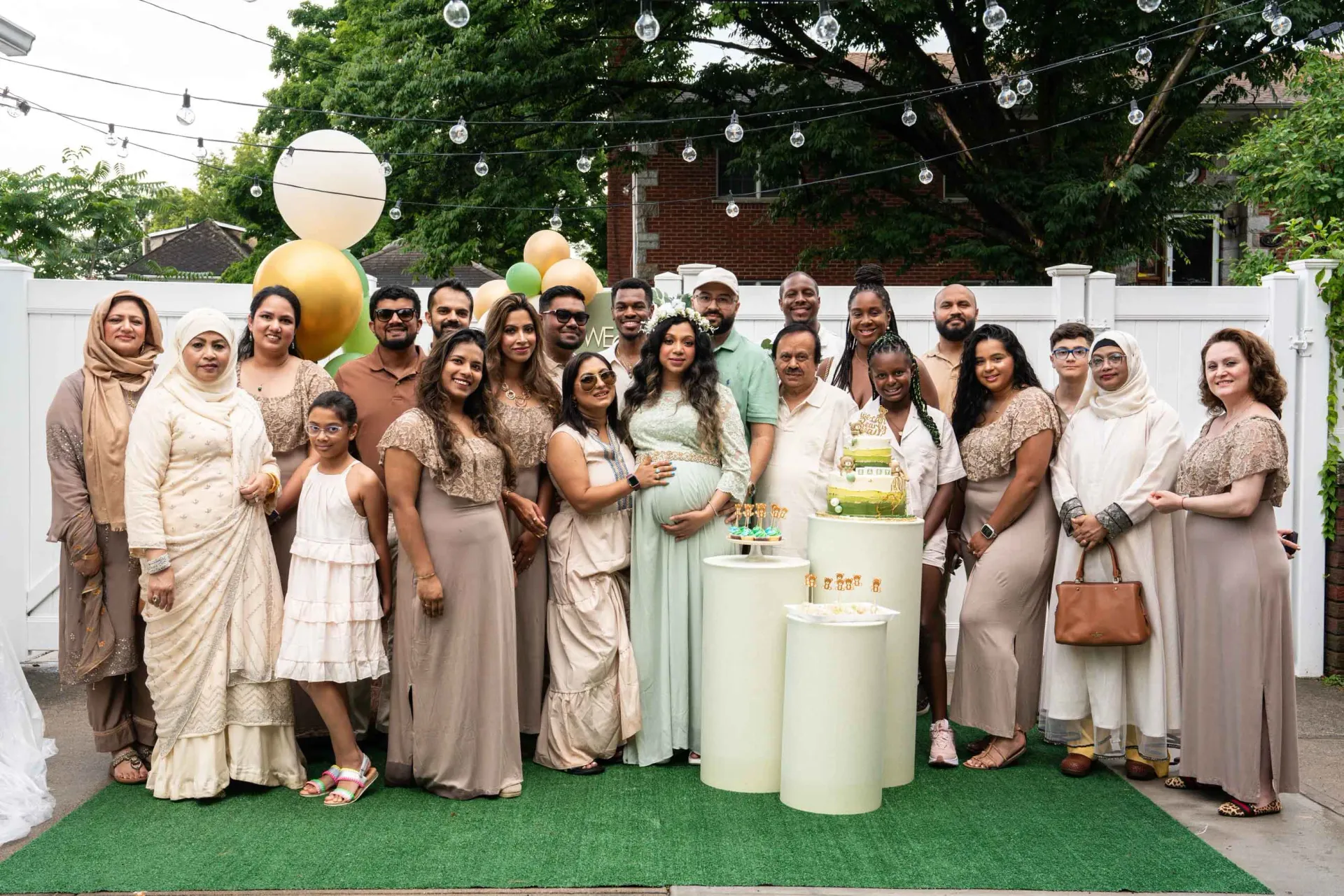 A large group of people are posing for a picture at a baby shower.