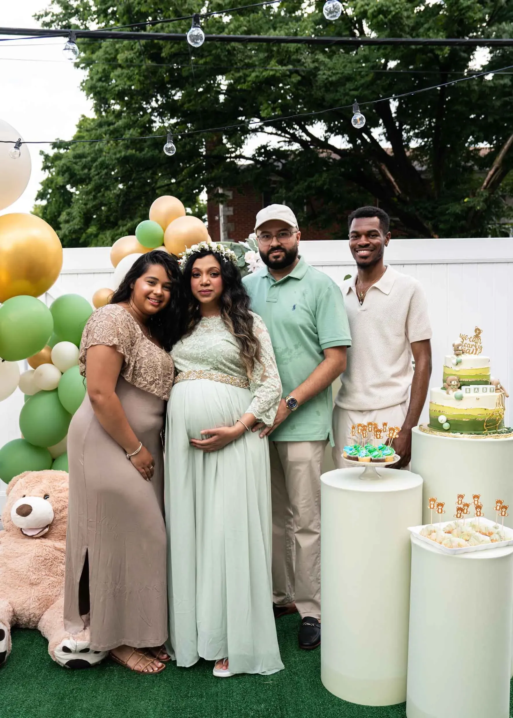 A group of people are posing for a picture at a baby shower.
