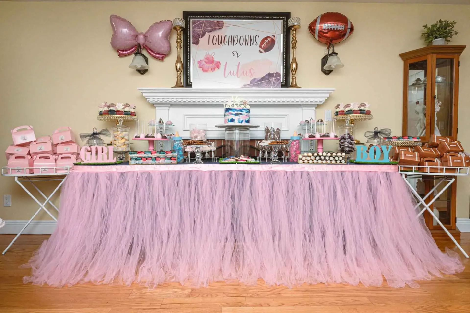 A pink tulle table skirt is sitting on top of a wooden table.