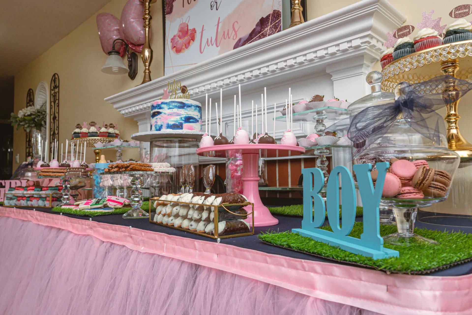 A table filled with lots of desserts and a sign that says boy.