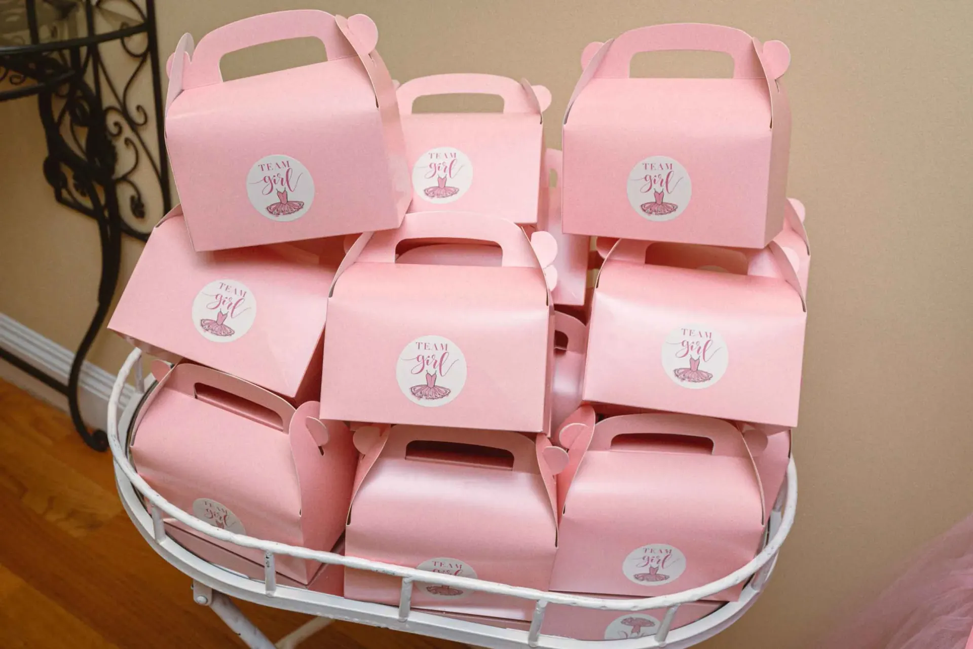 A basket filled with pink boxes with ballerinas on them