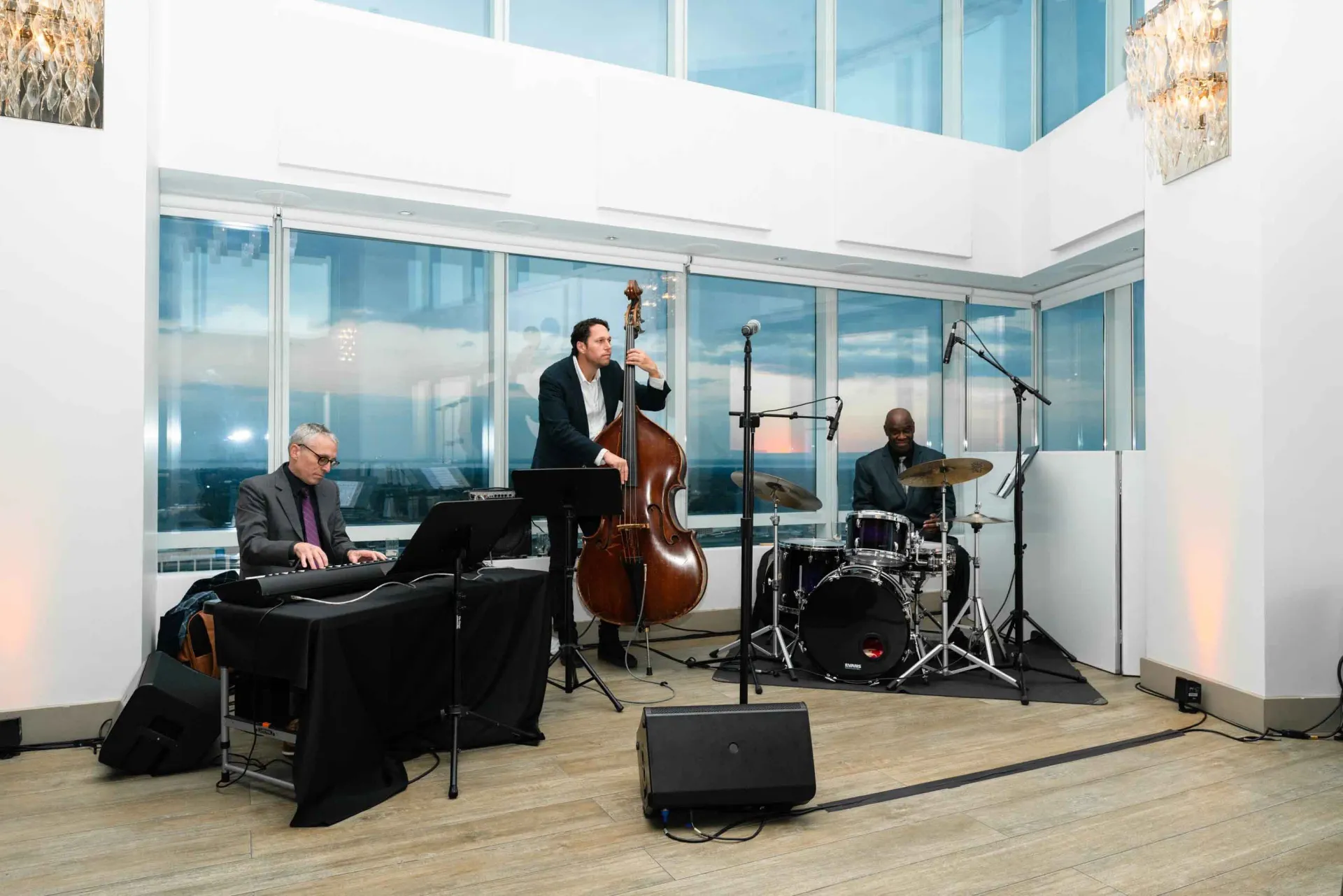 A group of men are playing instruments on a stage in a room.