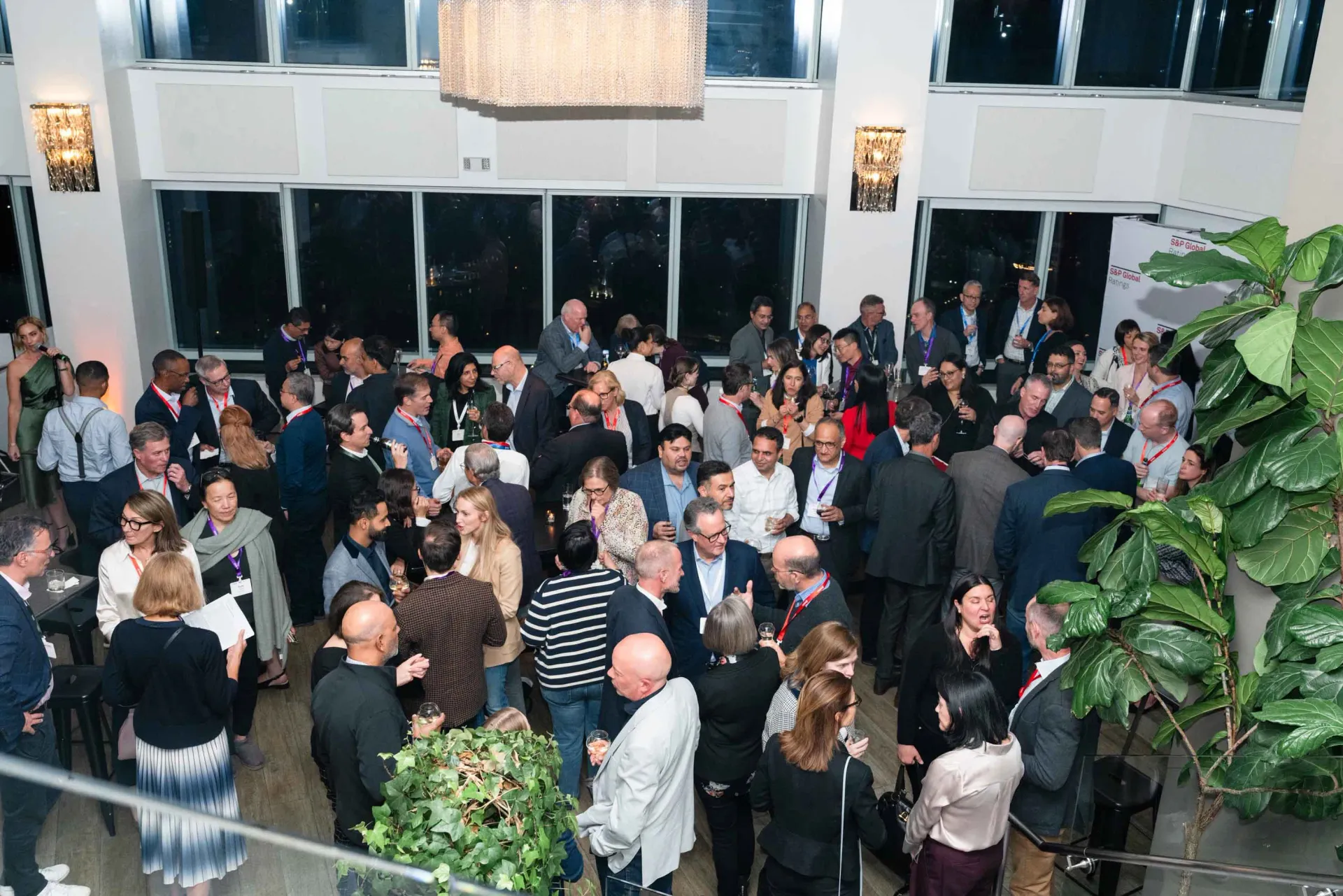 A large group of people are standing in a room.