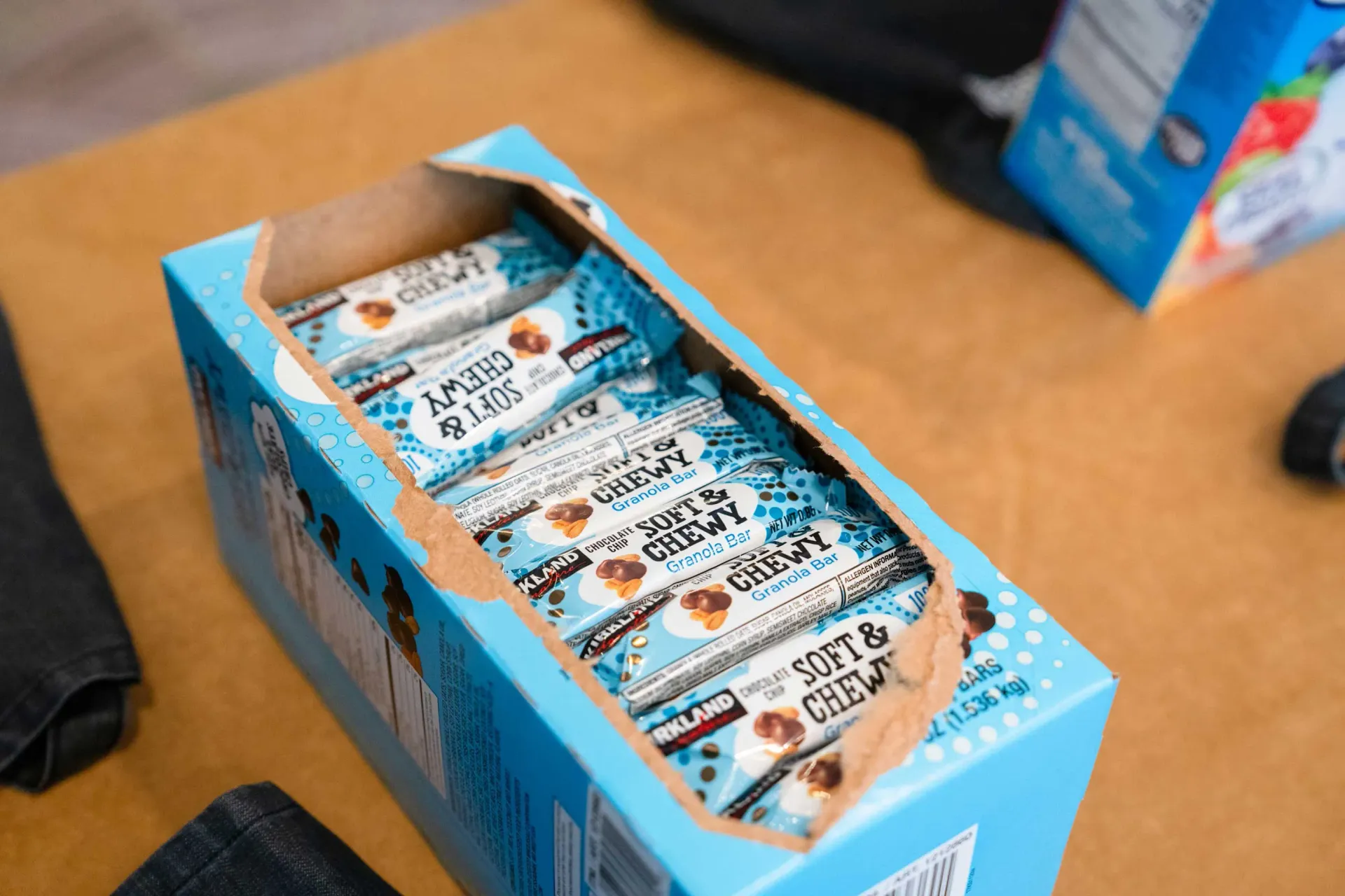 A box of candy bars is sitting on a wooden table.