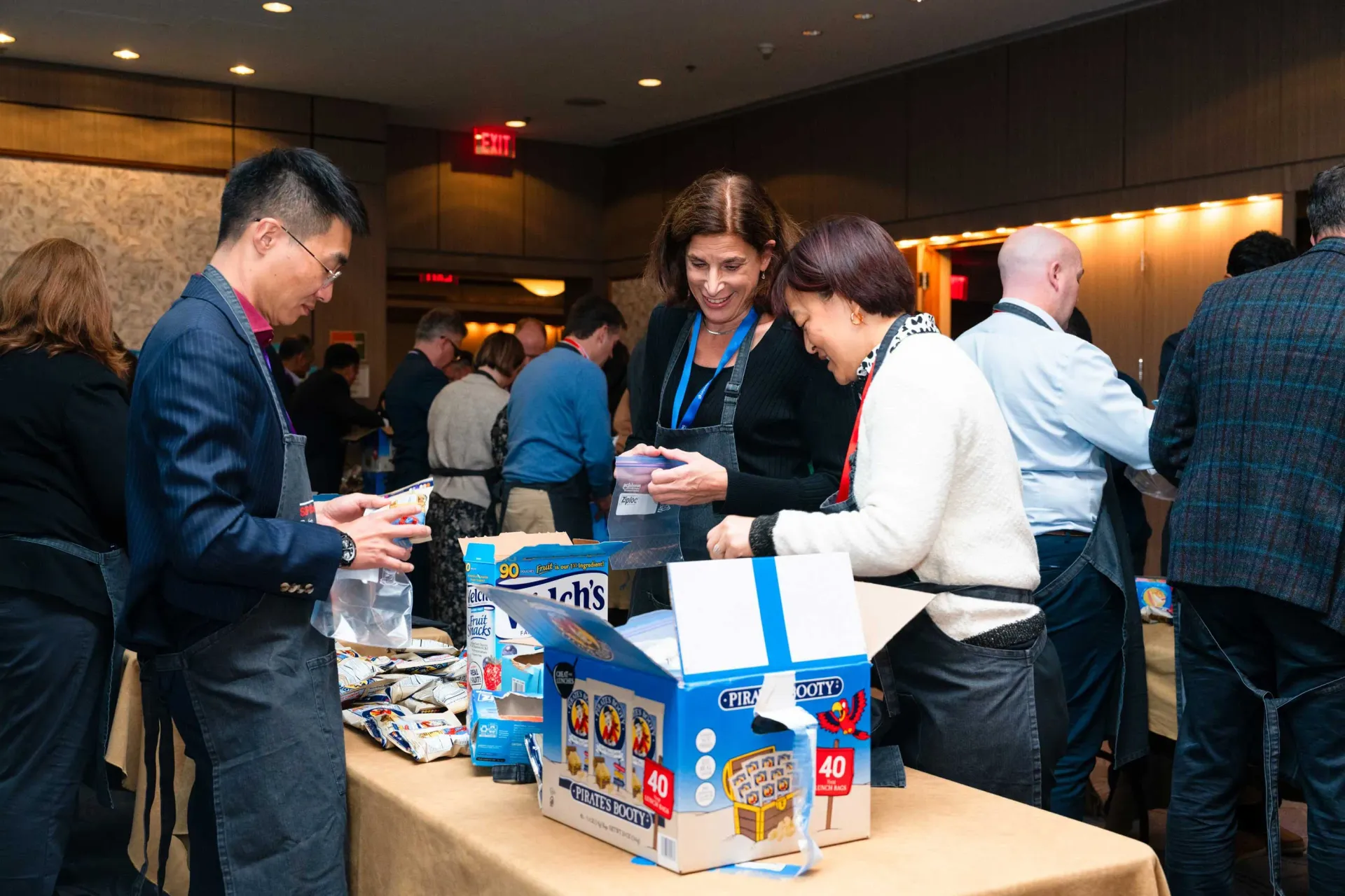 A group of people are standing around a table in a room.