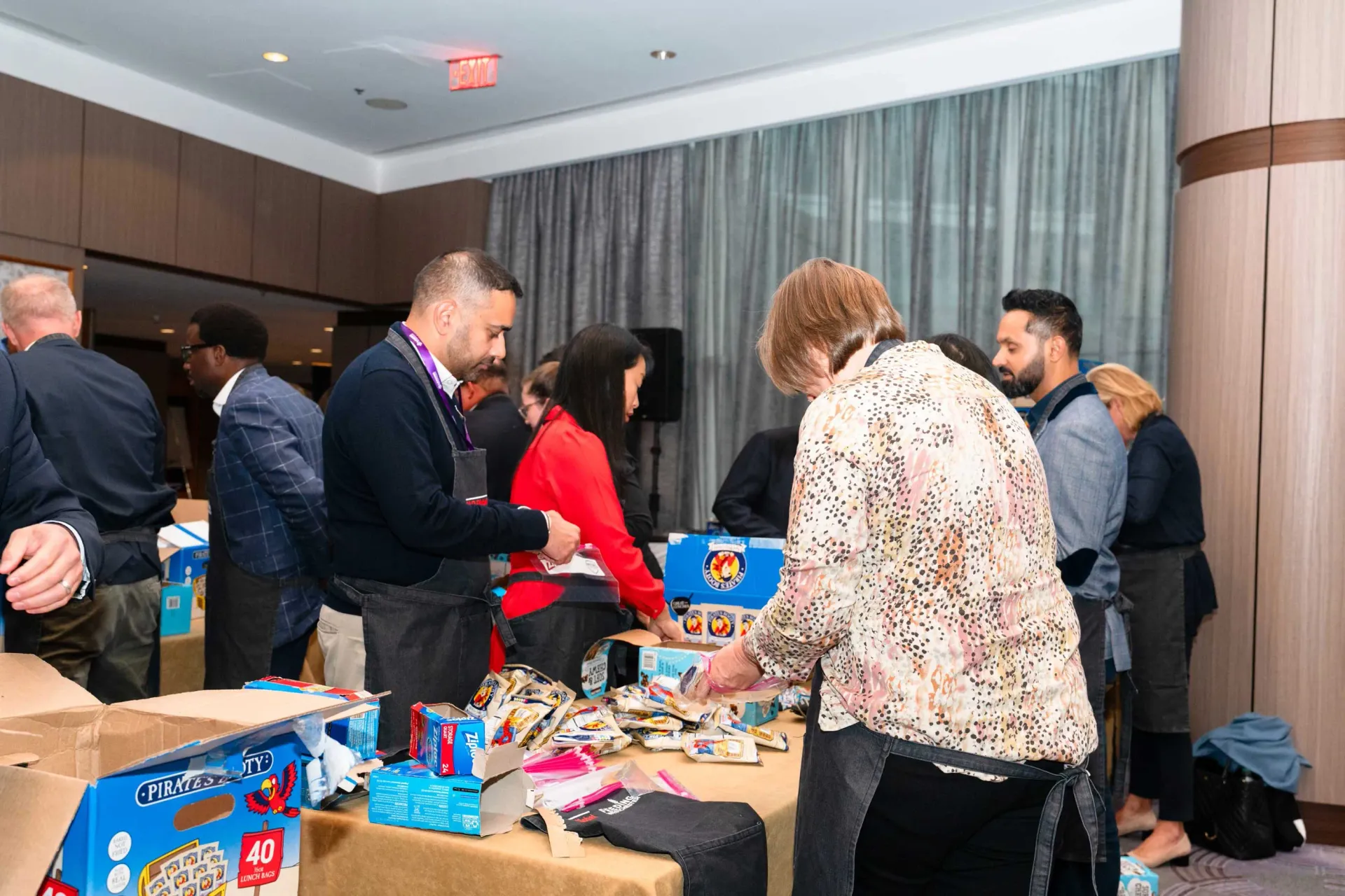 A group of people are standing around a table in a room.