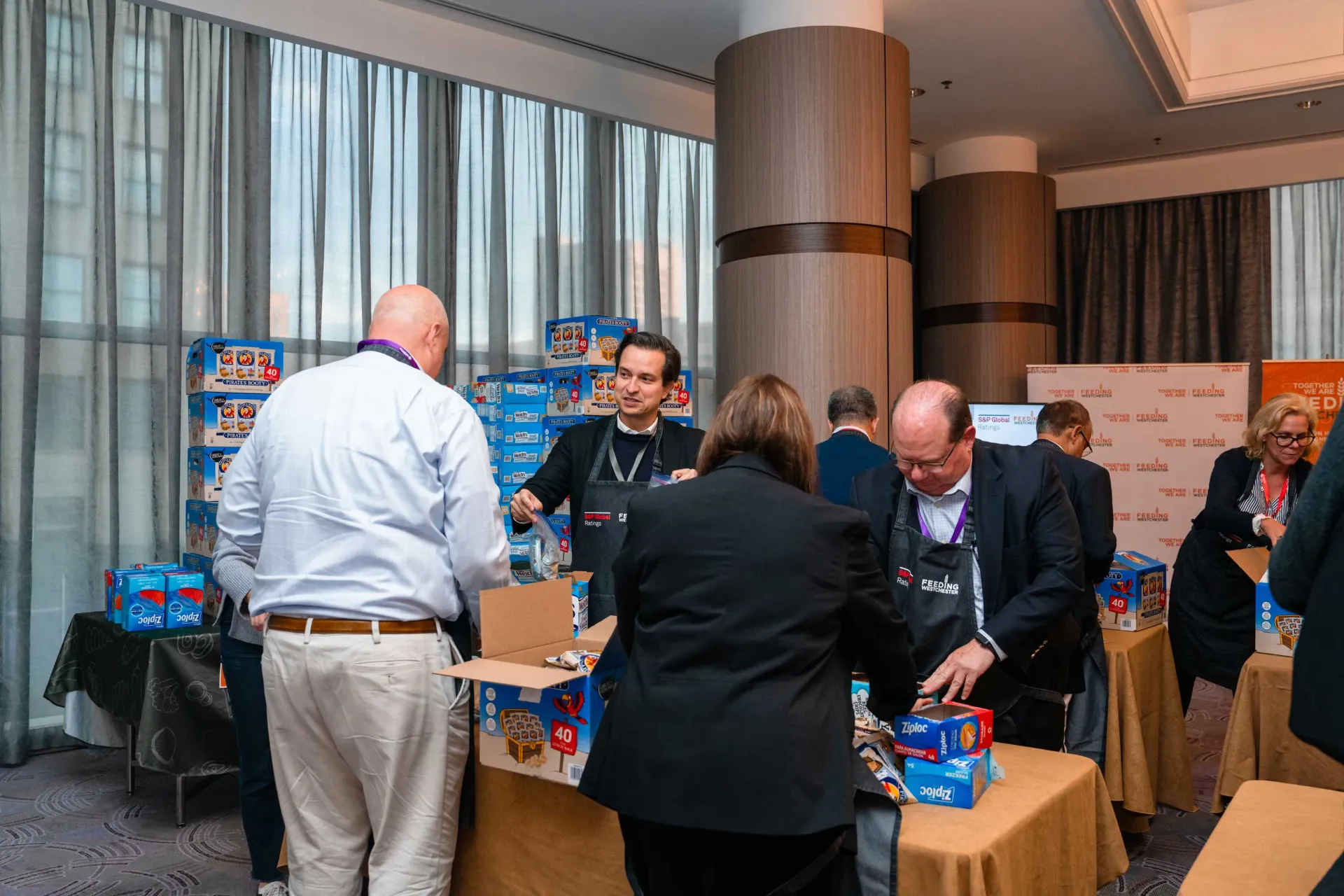 A group of people are standing around a table in a room.