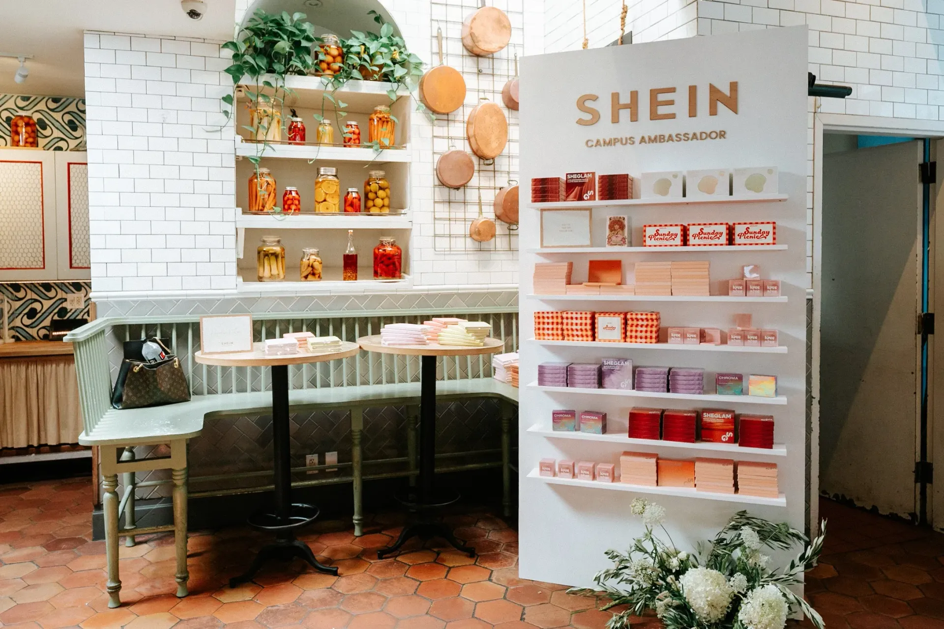 A room with a table , shelves and a sign that says shein.