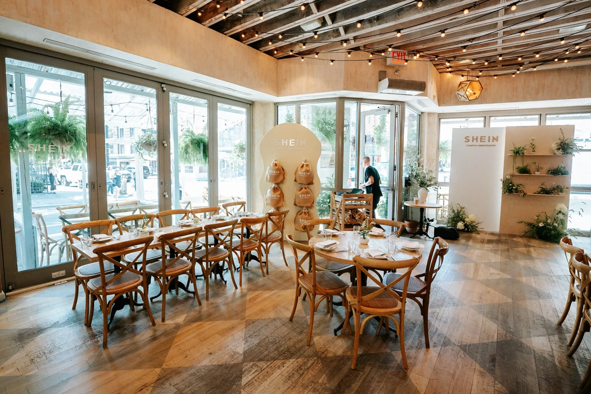A restaurant with tables and chairs and a large window.