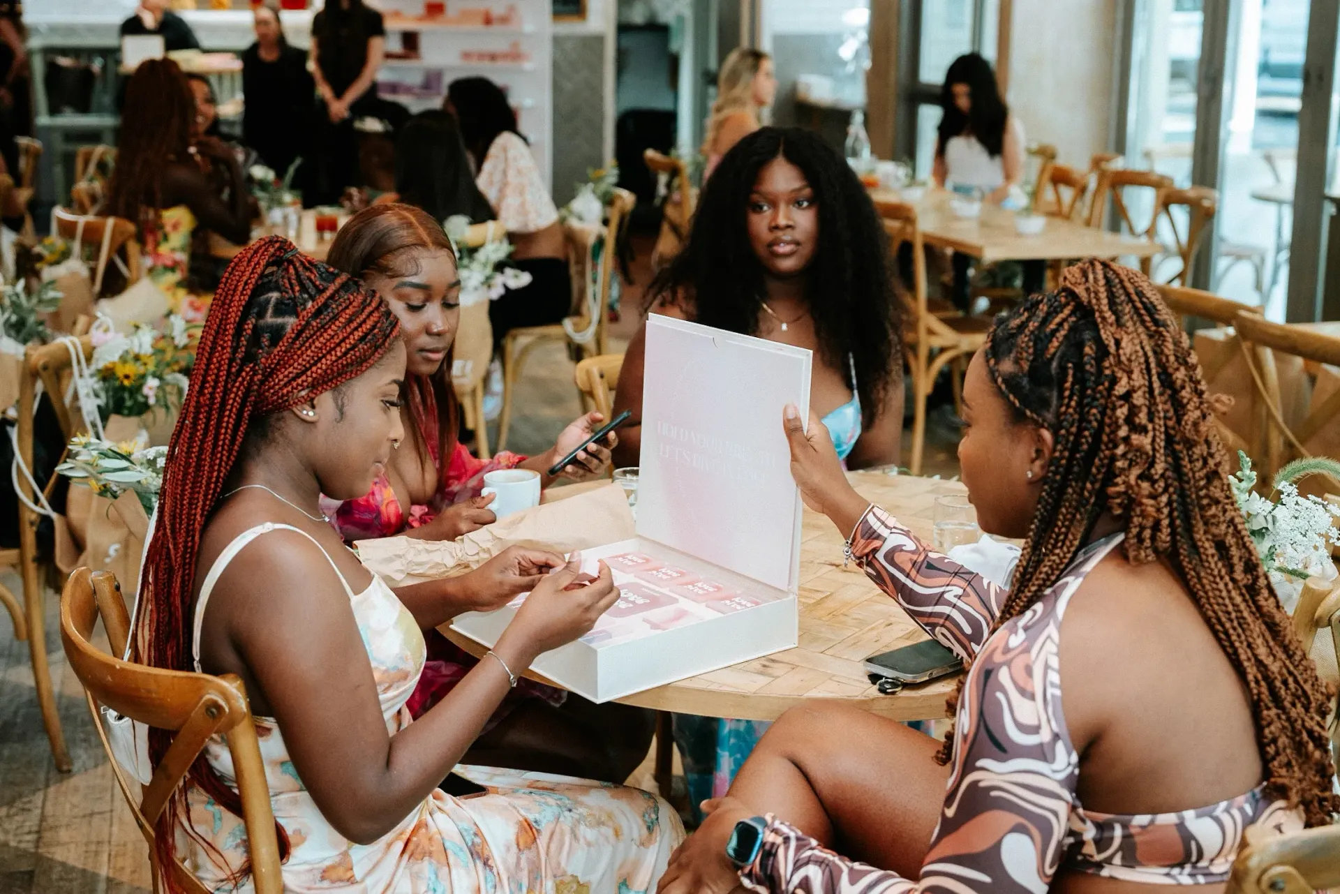 A group of women are sitting at a table in a restaurant.