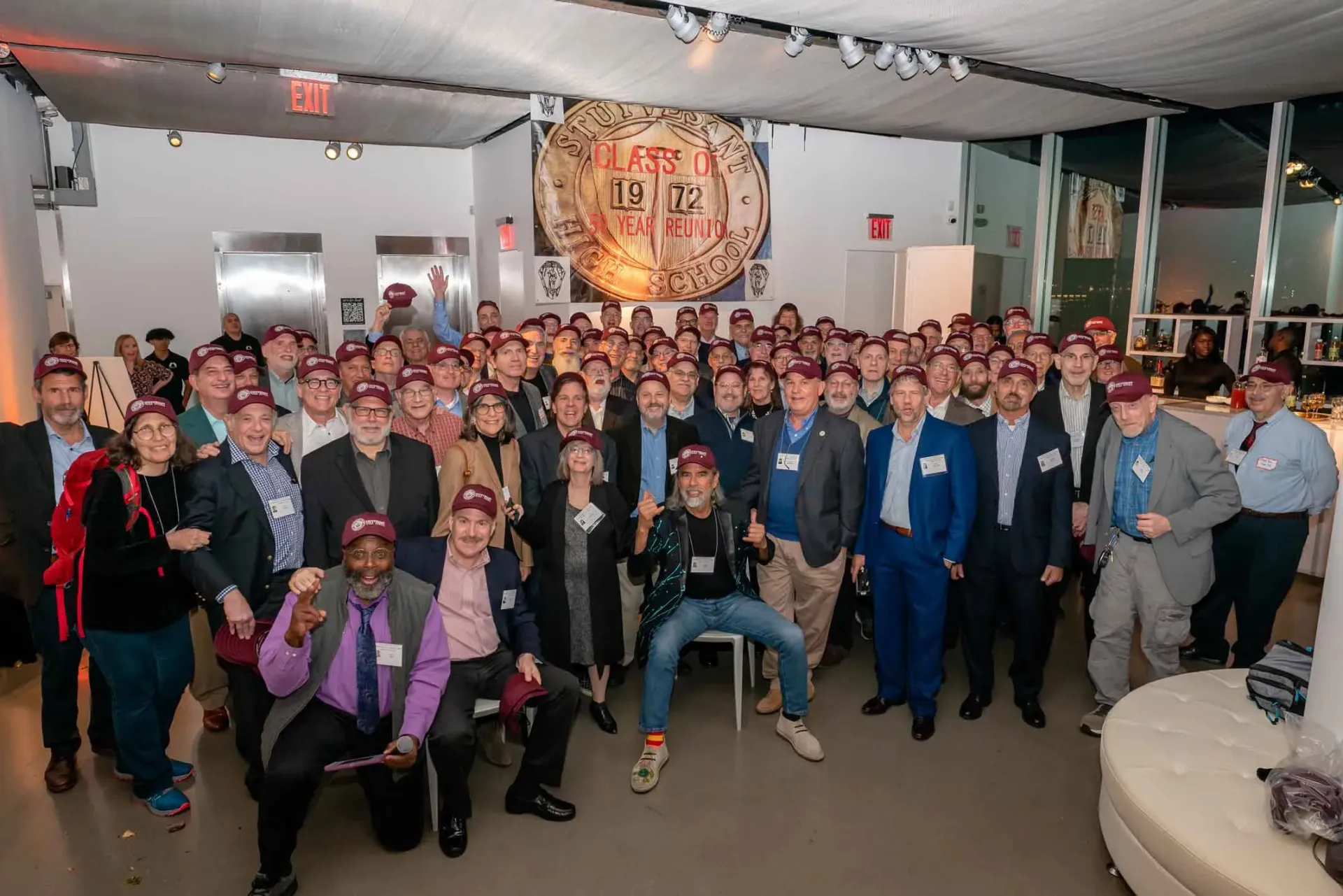 A large group of people are posing for a picture in a room.
