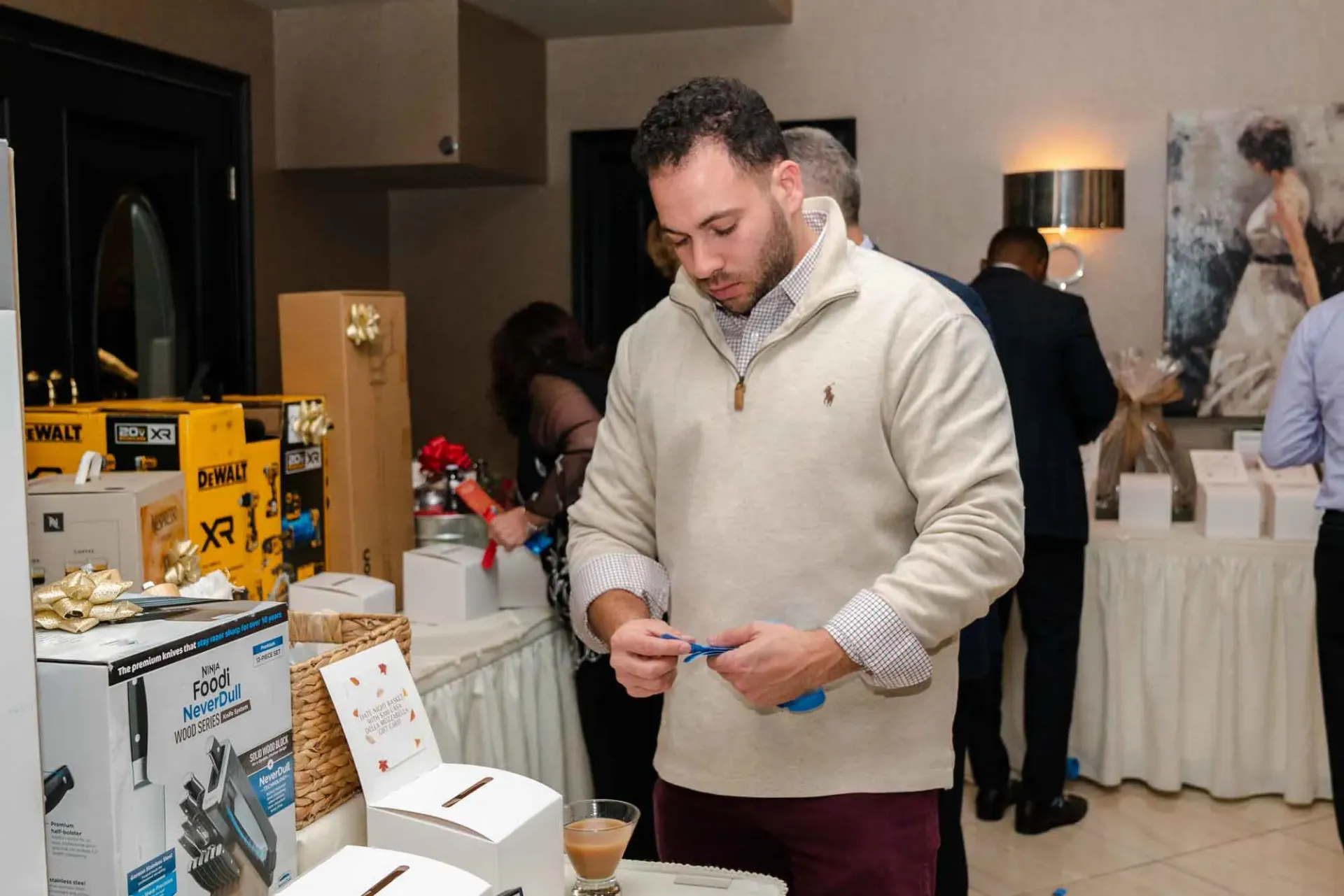 A man is standing in a room looking at a box.