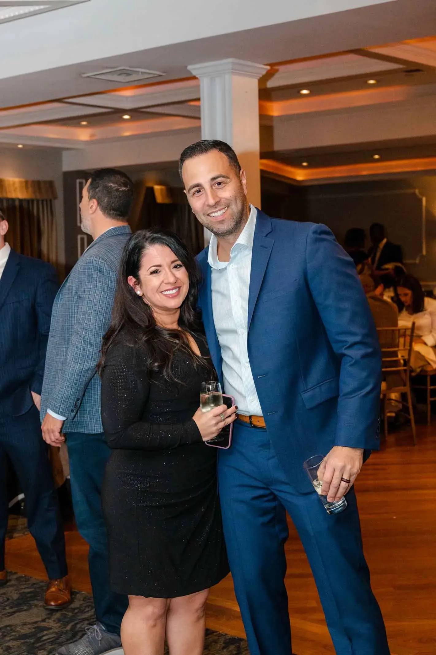 A man and a woman are posing for a picture at a party.