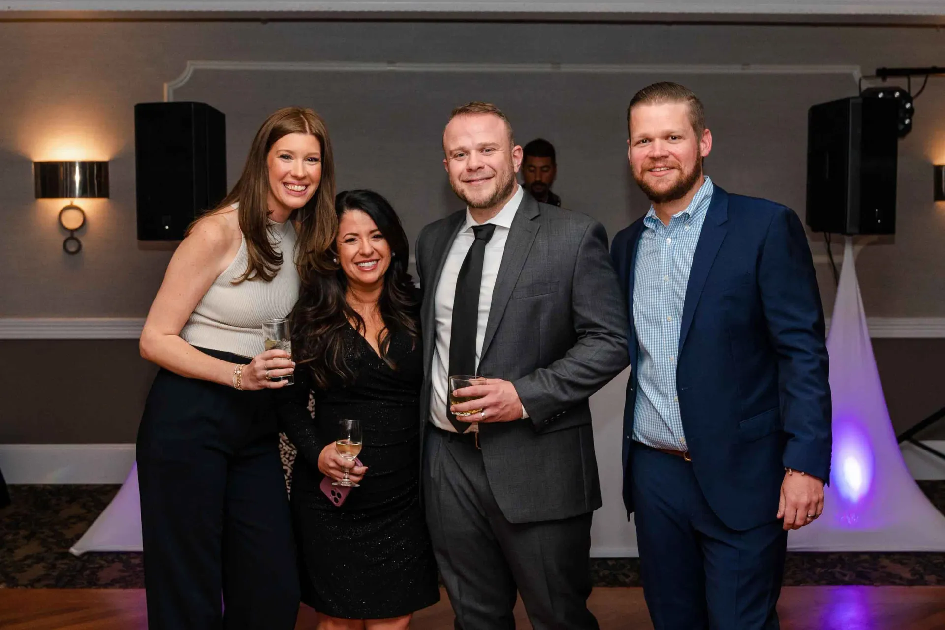 A group of people are posing for a picture at a party.