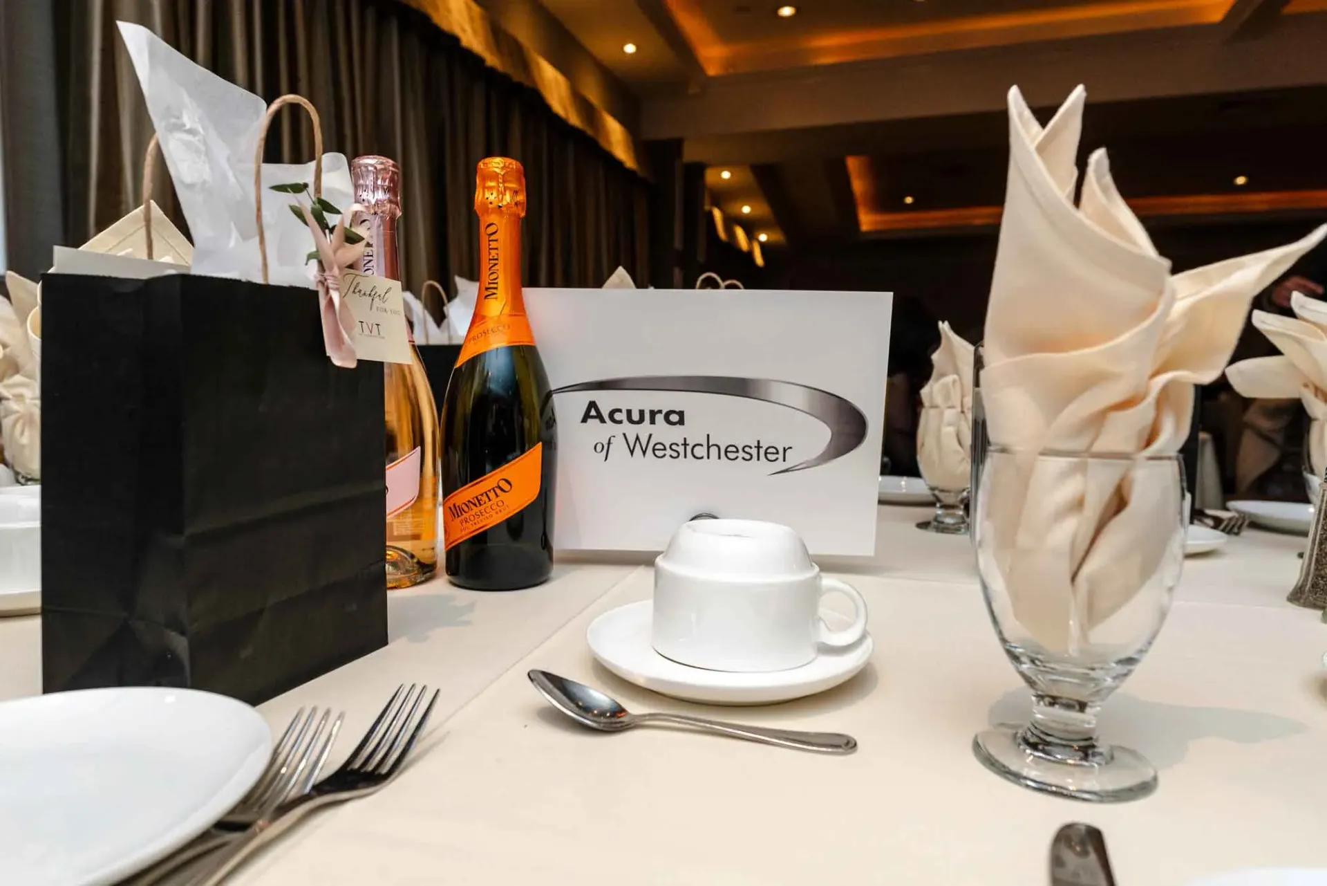 A table with a sign that says acura on it