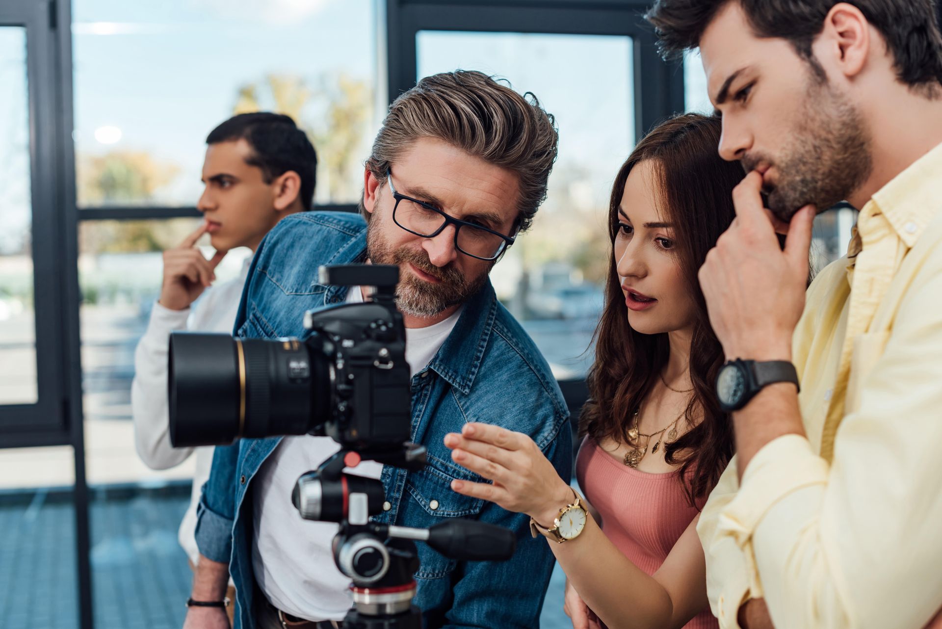A group of people are looking at a camera.