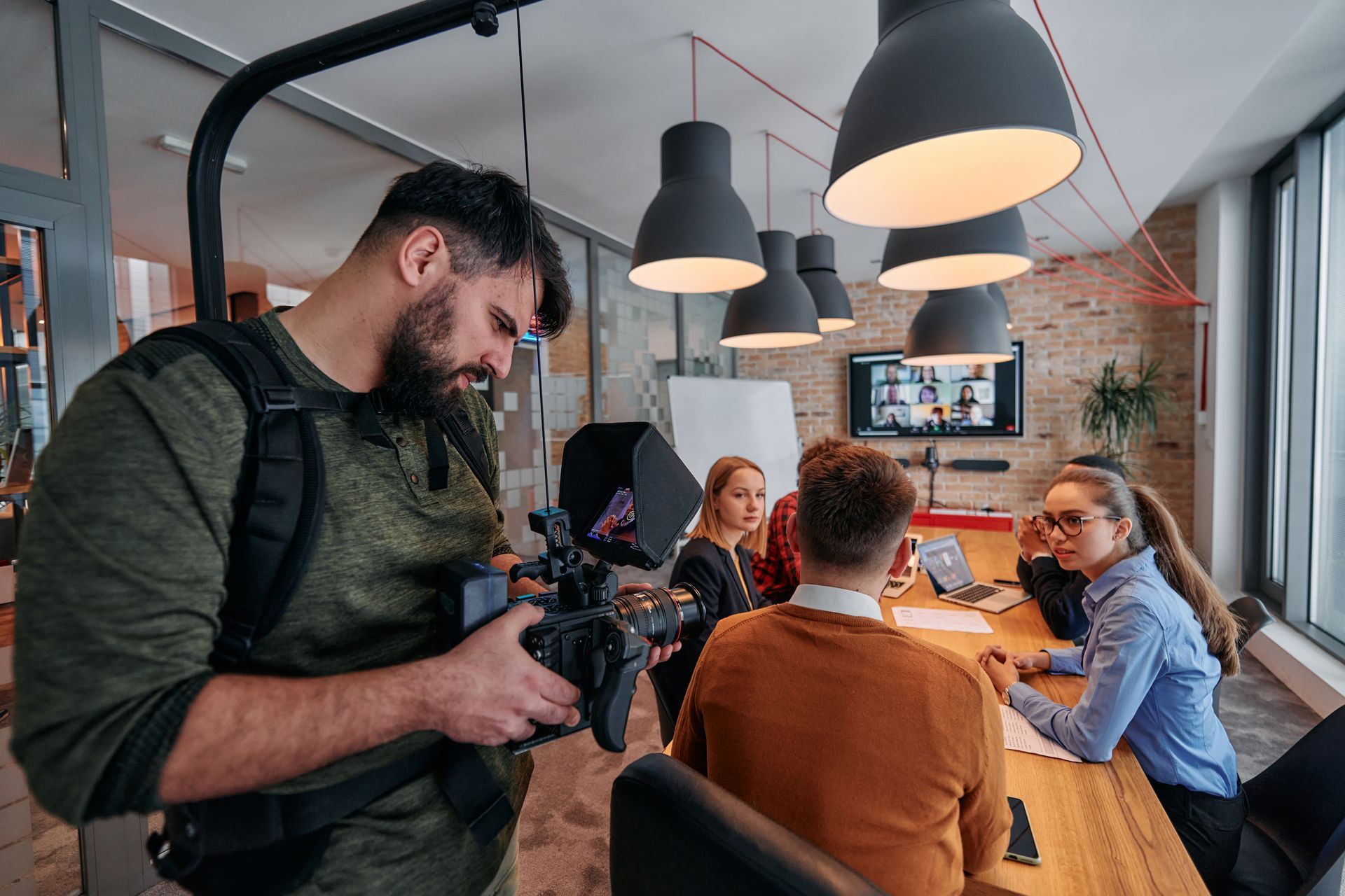 A group of people are looking at a camera.
