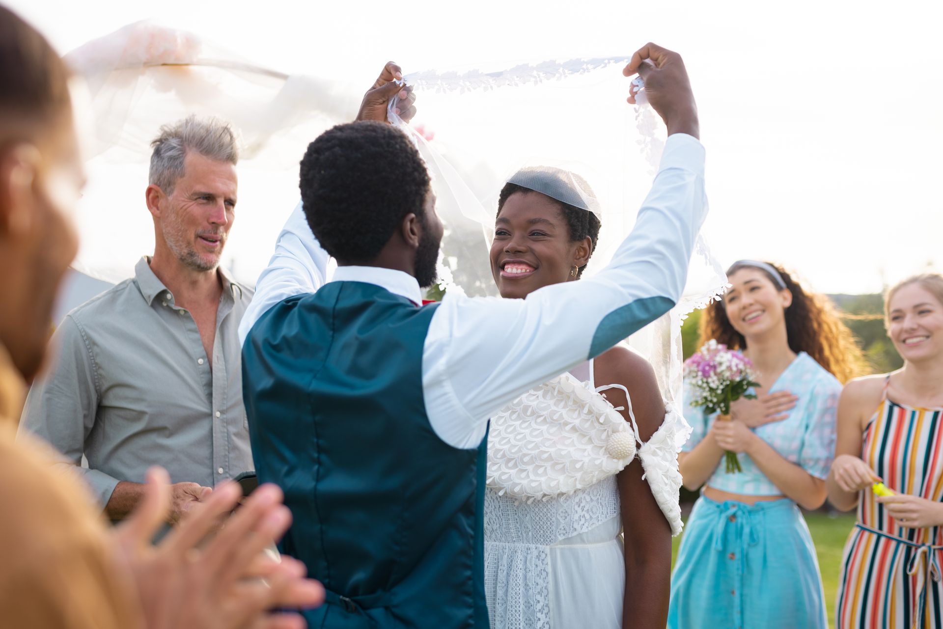 A bride and groom are celebrating their wedding with their wedding party.
