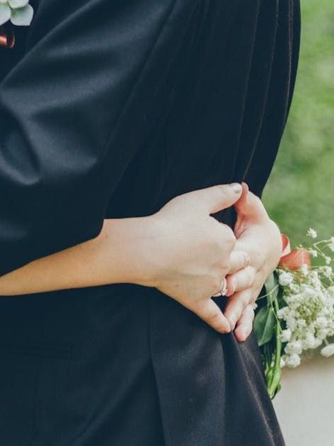 Two women are sitting at a table in a living room.