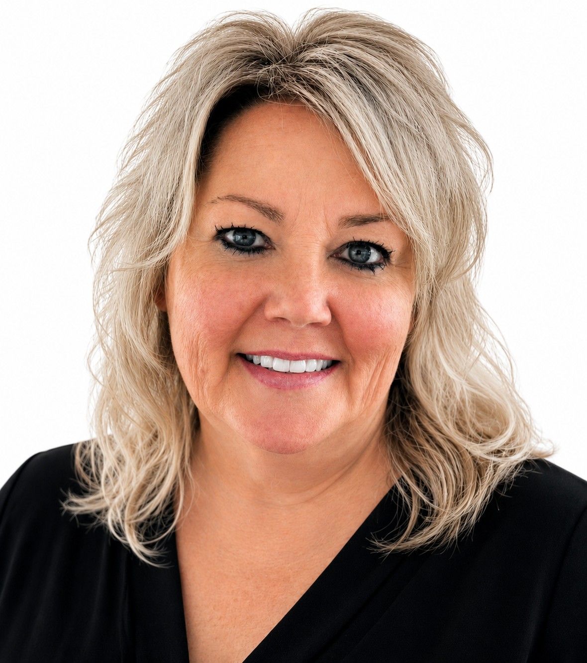 Smiling blonde woman in a black top against a white background