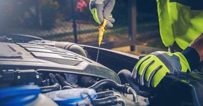 Service Center — Mechanic Inspecting a Car in Laredo, TX