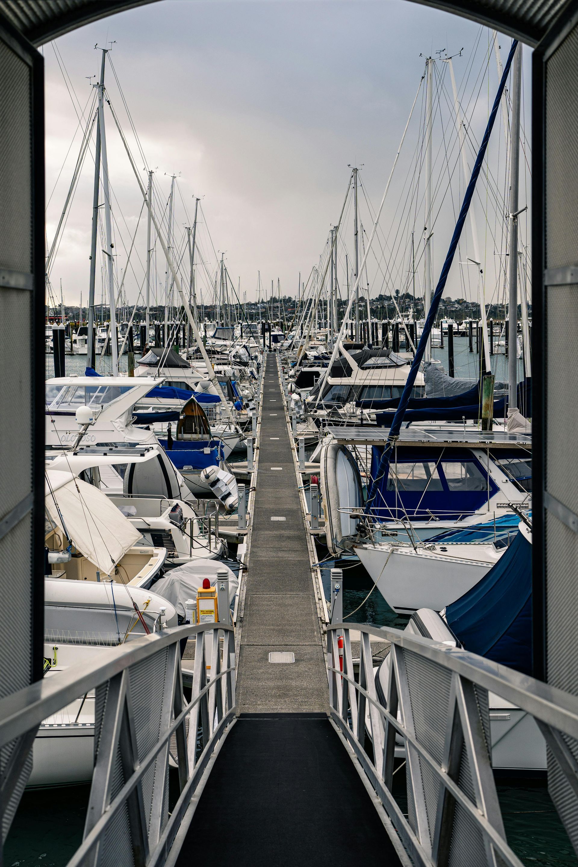 A row of boats are docked in a marina