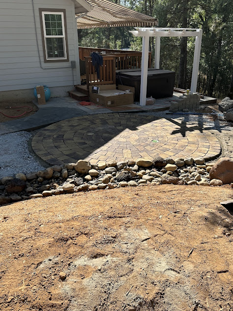 A house with a patio and a hot tub in the backyard.