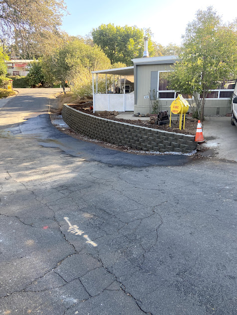 A concrete wall is being built in front of a house