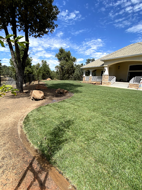 A large house with a lush green lawn in front of it.