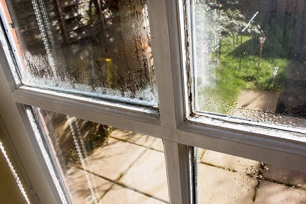 A close up of a window with condensation on it.