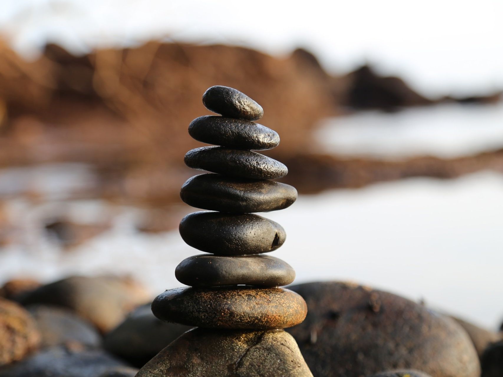 balancing rocks representing balance of cyber insurance cost and security