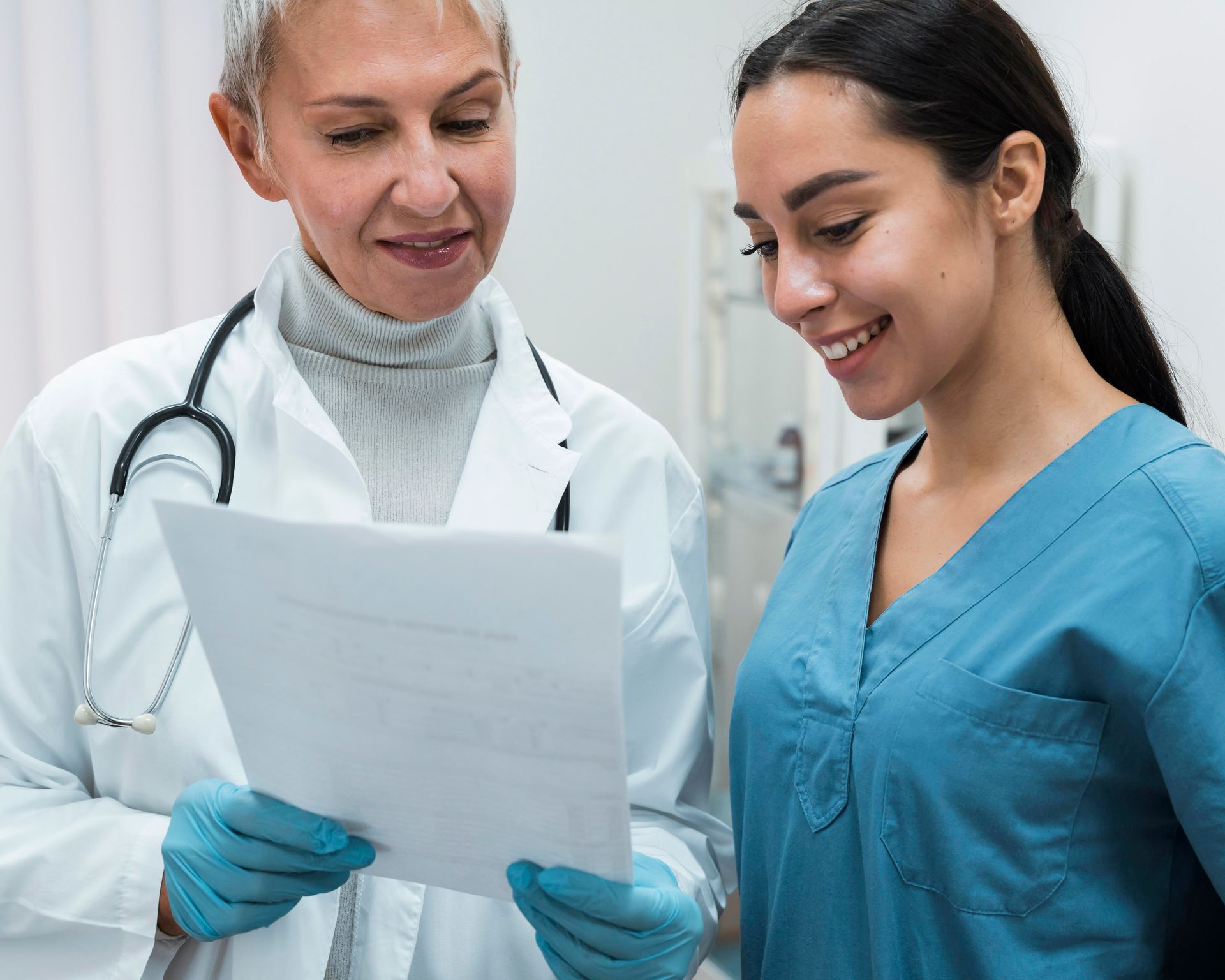 Two women in a positive atmosphere. One is holding a document in her gloved hands