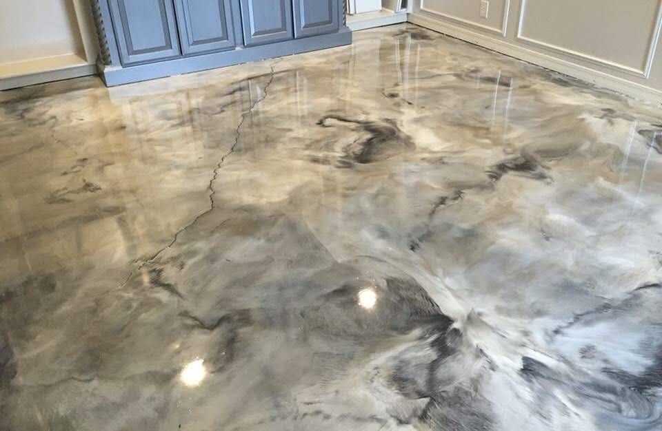 Glossy epoxy flooring in shades of gray and white resembling marble.