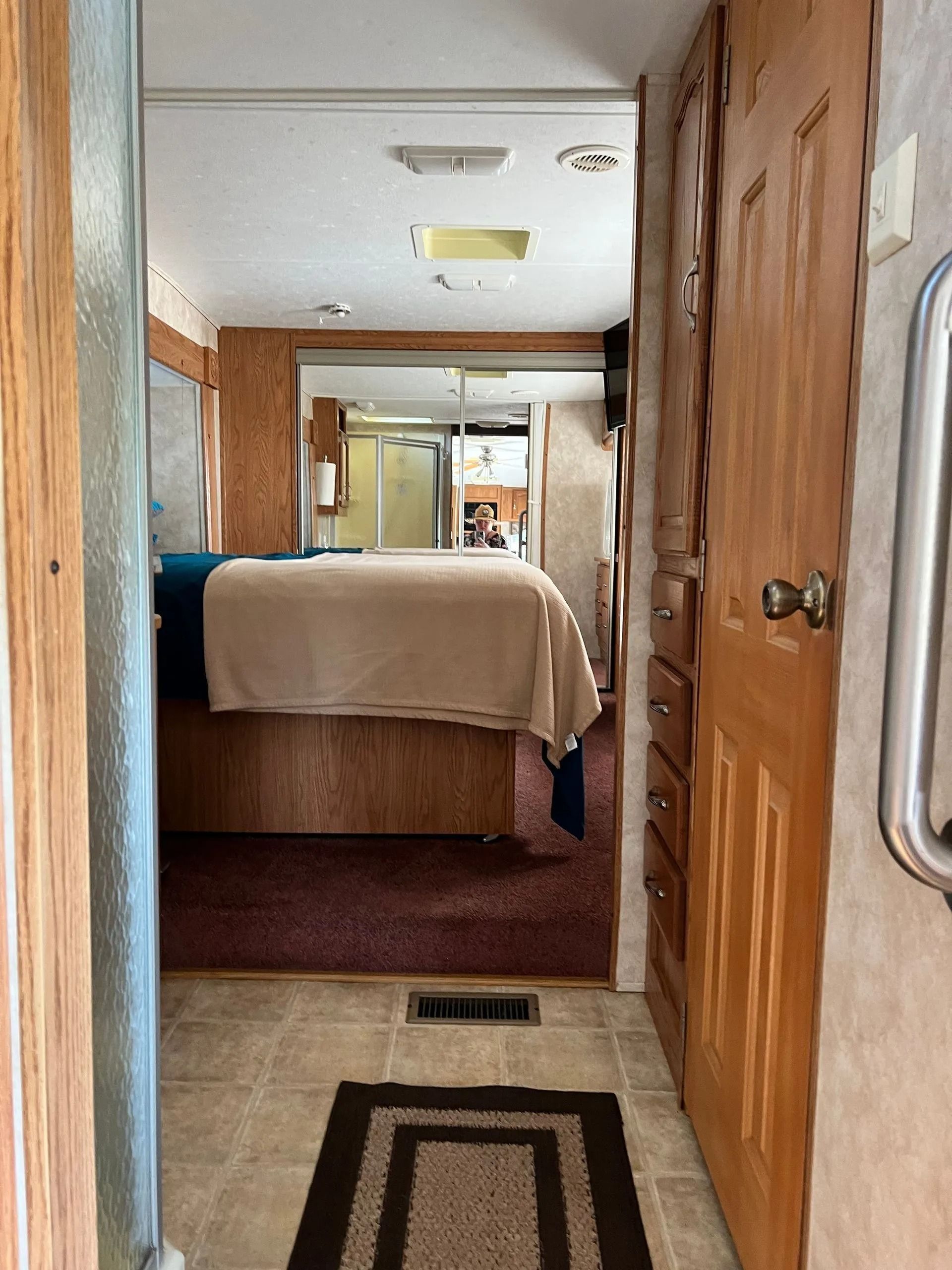 A bedroom with a bed and a doorway leading to it