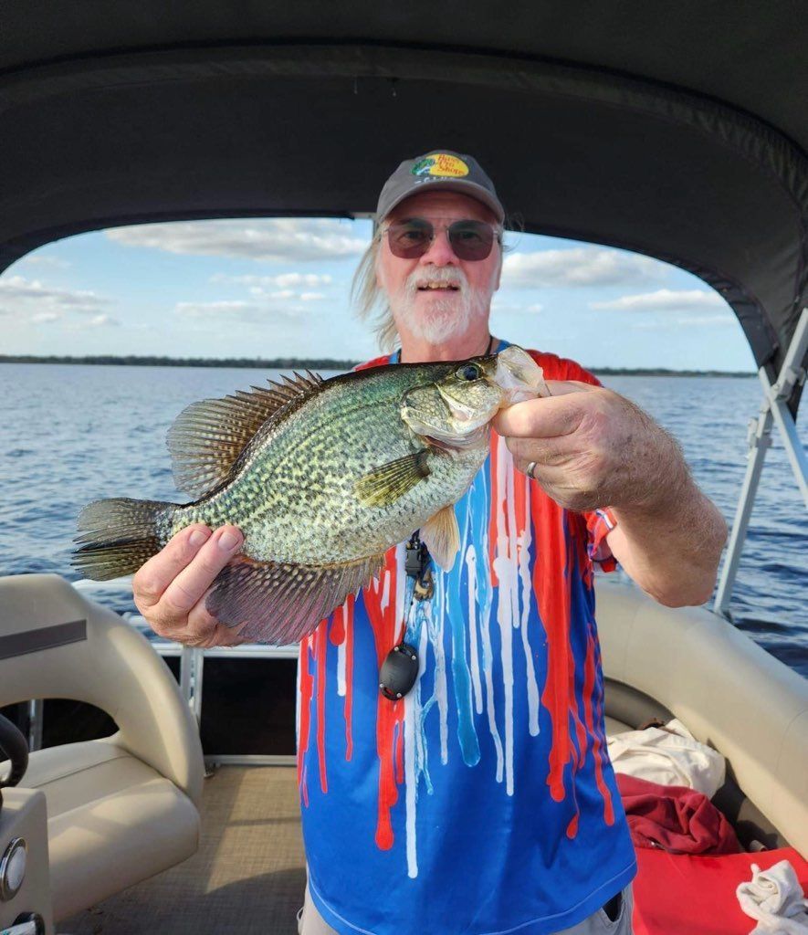 A man is holding a fish on a boat.