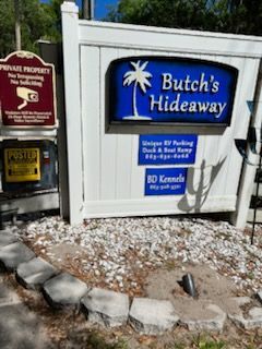 A butch 's hideaway sign with a palm tree on it