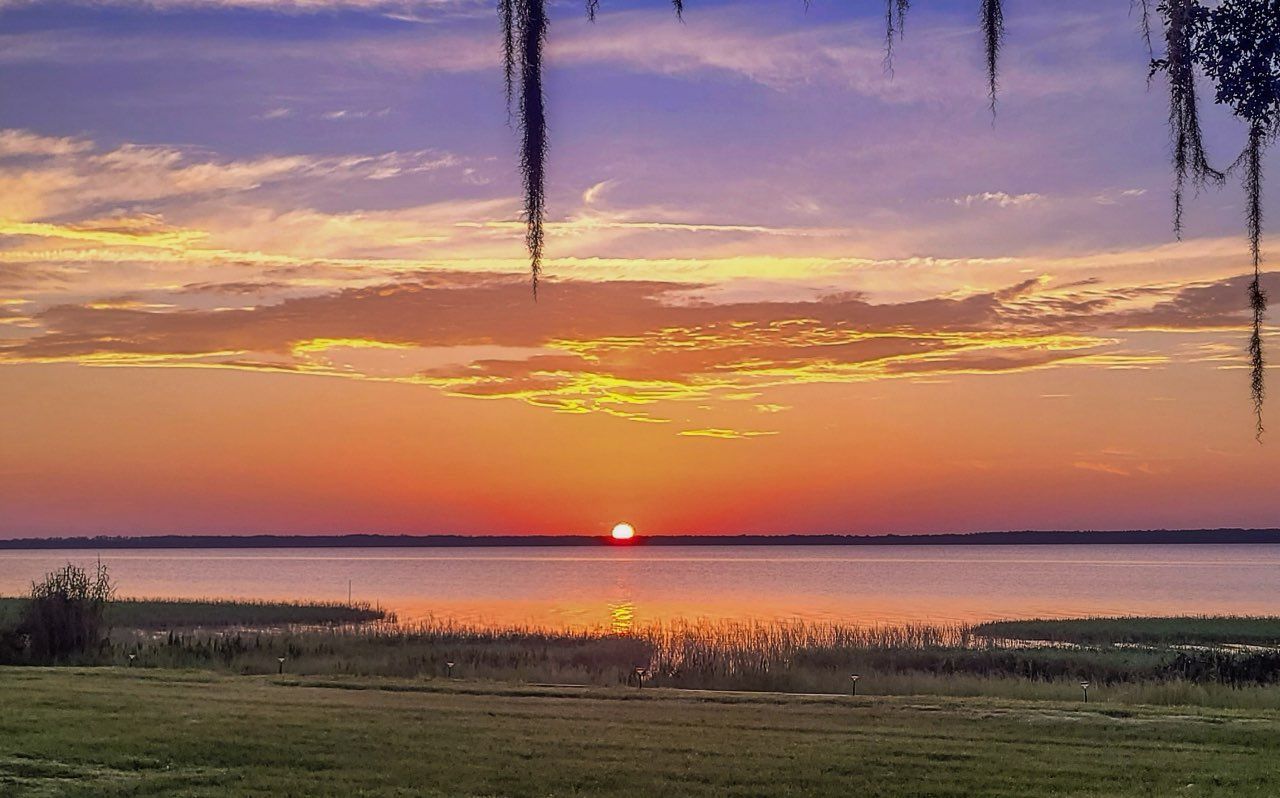 The sun is setting over a body of water.