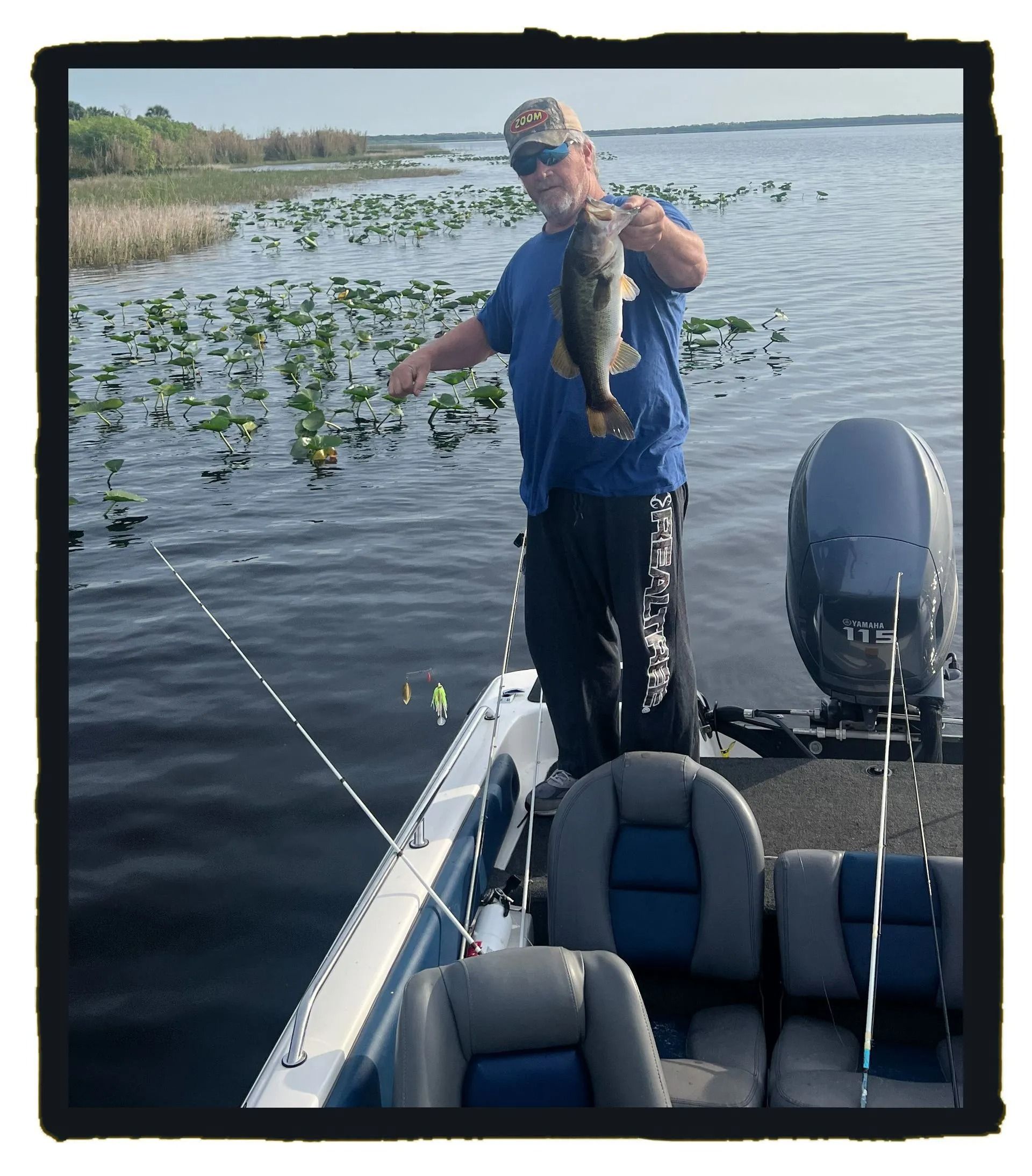 A man standing on a boat holding a fish