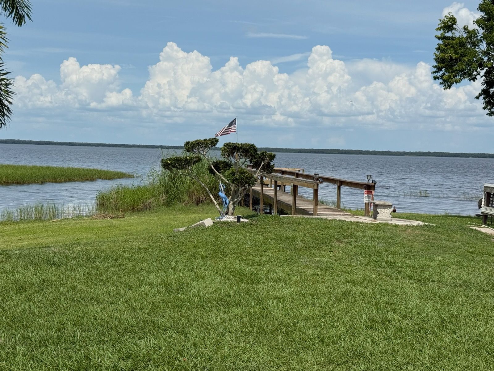 A view of a lake from a balcony with stairs leading up to it.