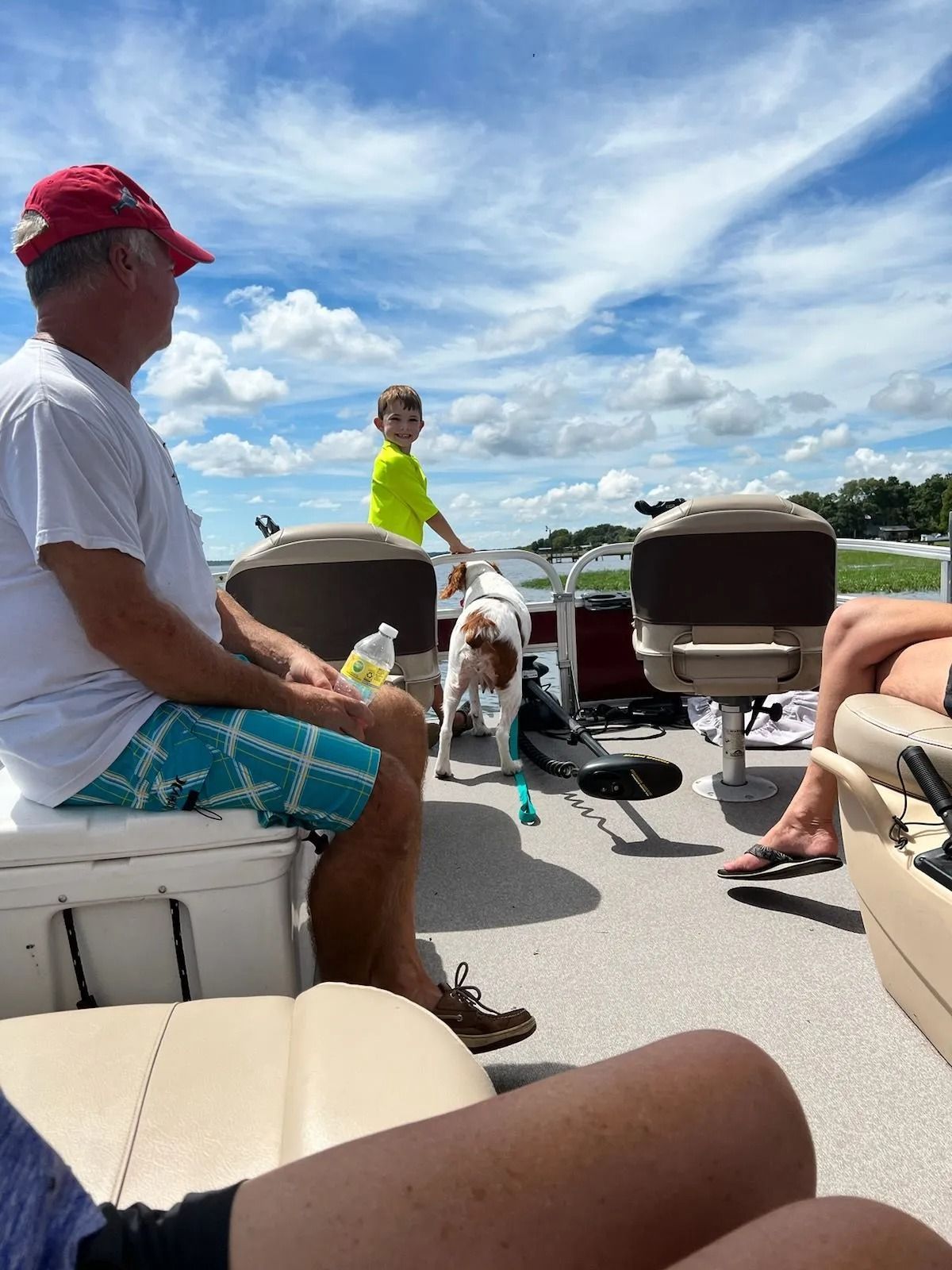 A group of people are sitting on a pontoon boat.