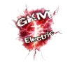 GKM Electric logo: White text over a red and white electric burst.