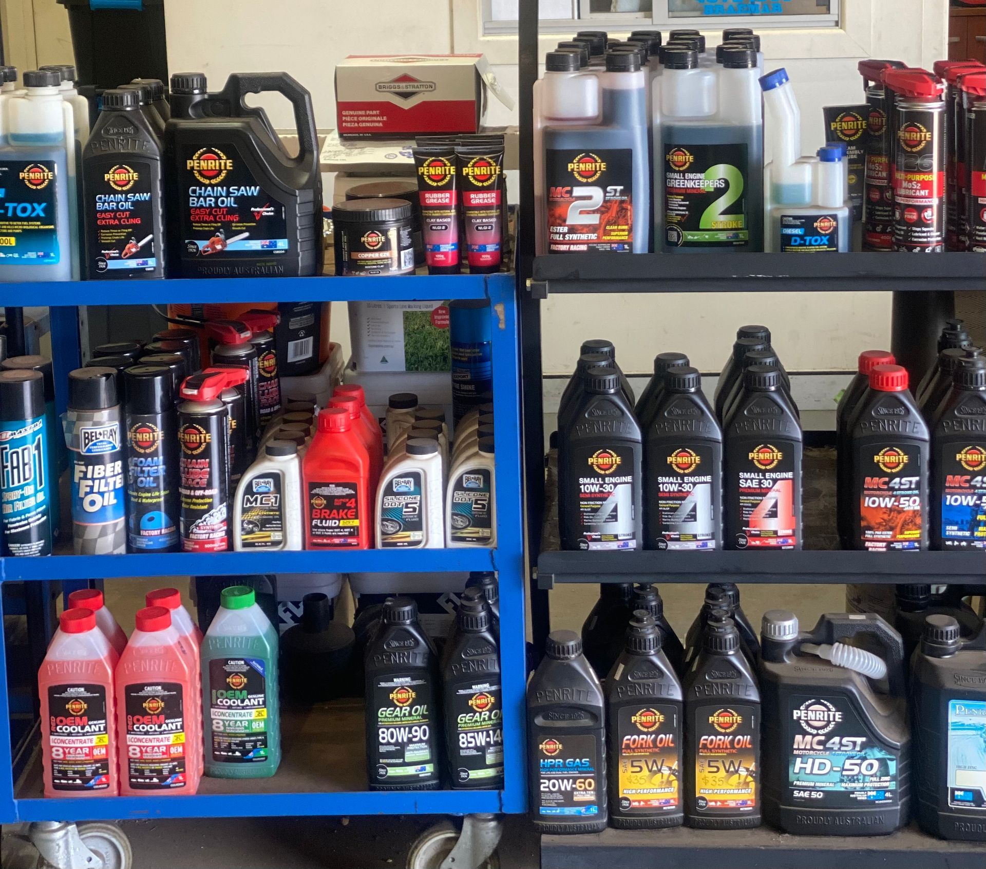 A shelf full of bottles including one that has the number 2 on it — Shamrock Mower & Motorcycle Repairs in Braemar, NSW