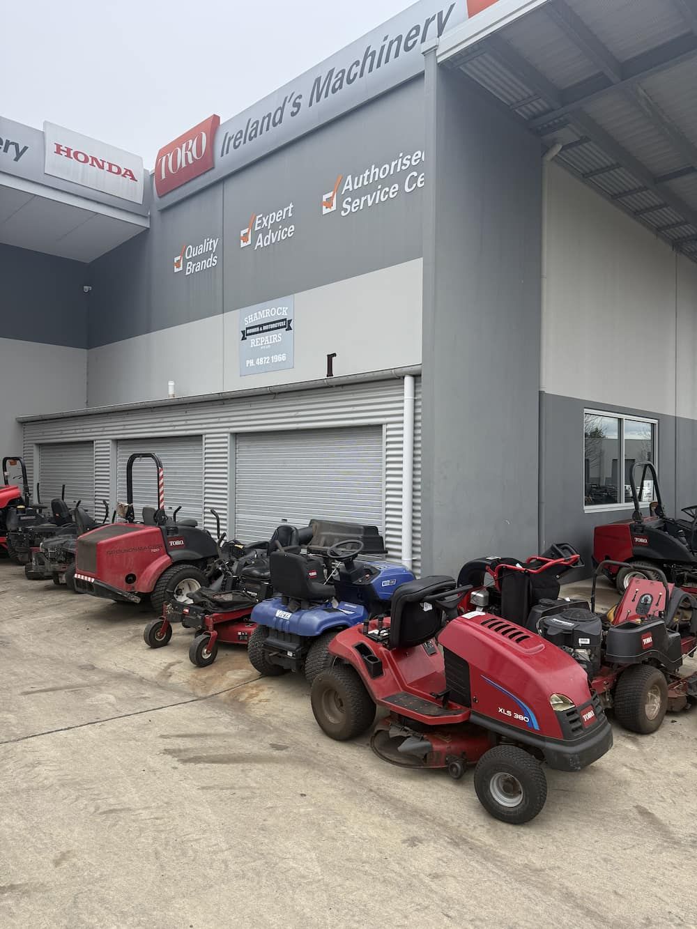 A bunch of lawnmowers are parked in a shed — Shamrock Mower & Motorcycle Repairs in Braemar, NSW