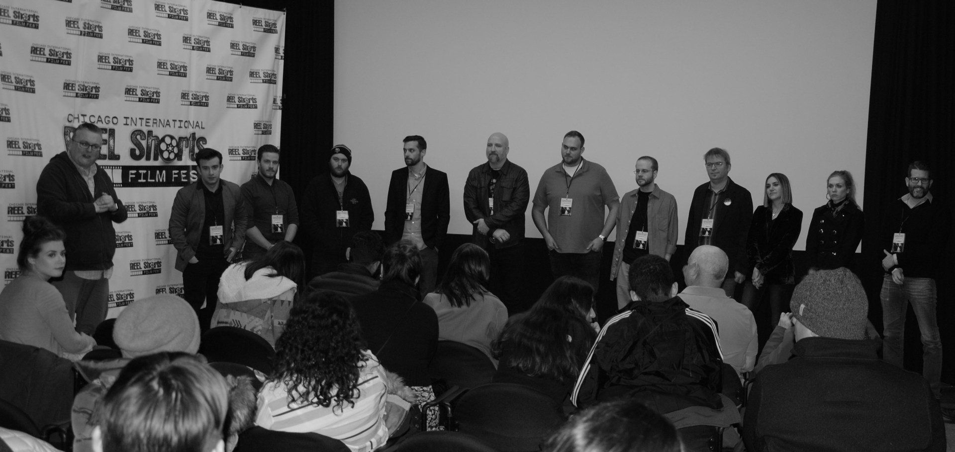 Panel of people on stage in front of an audience at a film event.