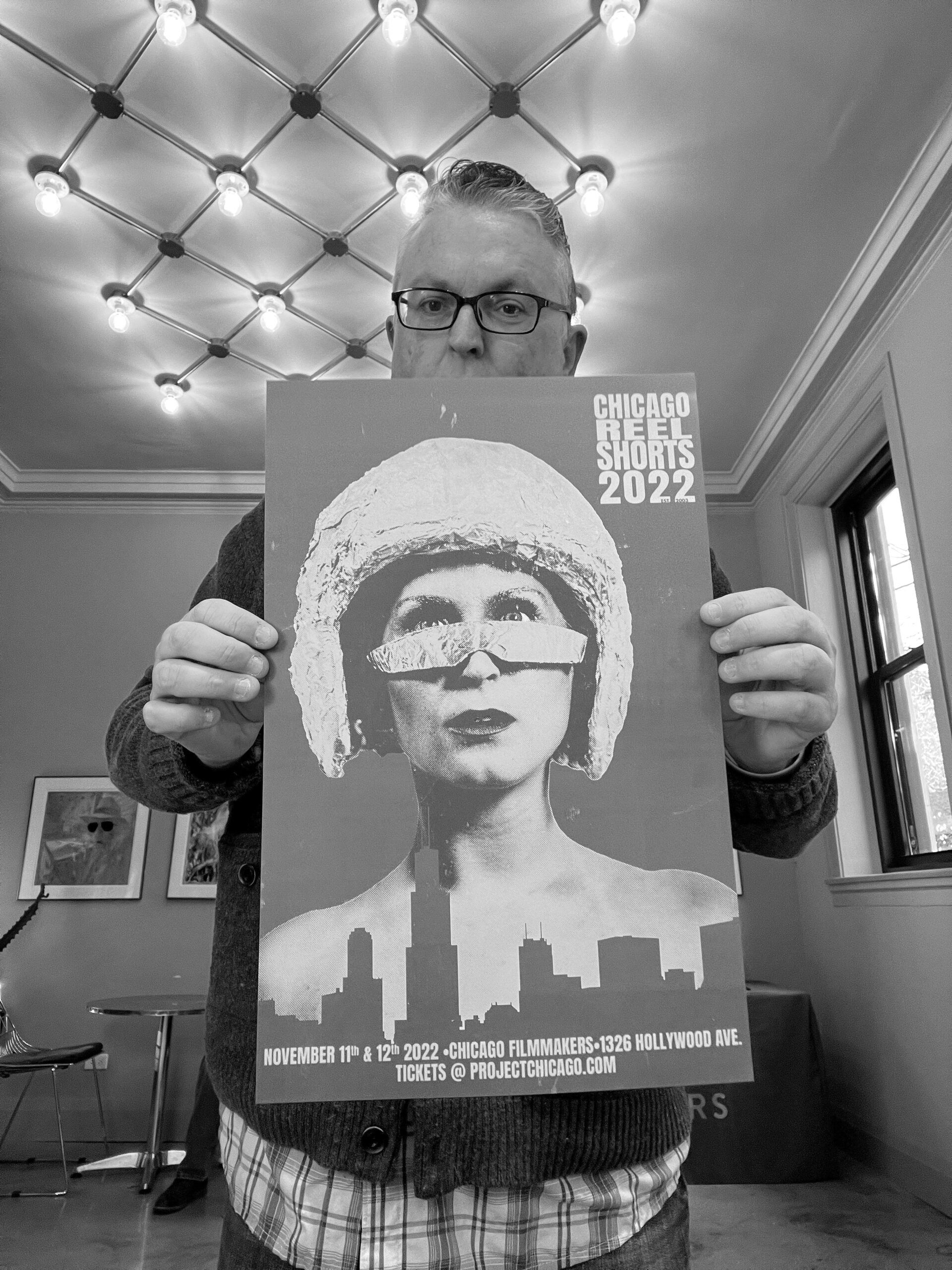 A man is holding a poster that says chicago film festival 2022