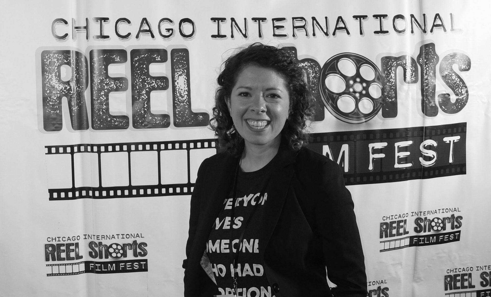 Woman smiling in front of a 